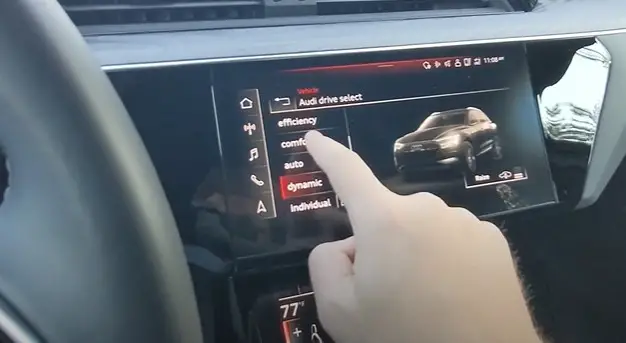 hand selecting display setting on Audi e-tron