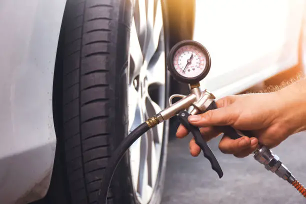 a man checking tyre pressure